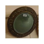 Small circular bevelled wall mirror in brass vine decorated frame, 14" diameter