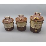 Graduated set of three early 20th century pottery tobacco jars, all with inscriptions, largest 7 1/