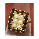 Mid-grade yellow metal dress ring, the rectangular shaped ring set with six seed pearls surrounded