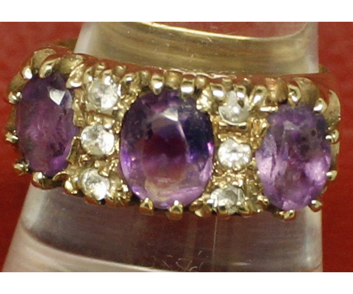 9ct gold hallmarked ring, set with three purple stones and six small paste stones, finger size O,