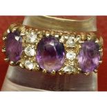 9ct gold hallmarked ring, set with three purple stones and six small paste stones, finger size O,