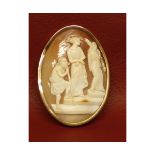 Victorian oval cameo brooch, the shell carved depicting three figures in a yellow metal frame (frame