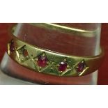 Late 19th century 15ct gold and ruby ring, the plain band set with four small oval cut rubies (one