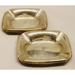 Pair of George V ashtrays, each of polished rectangular form with canted corners and polished