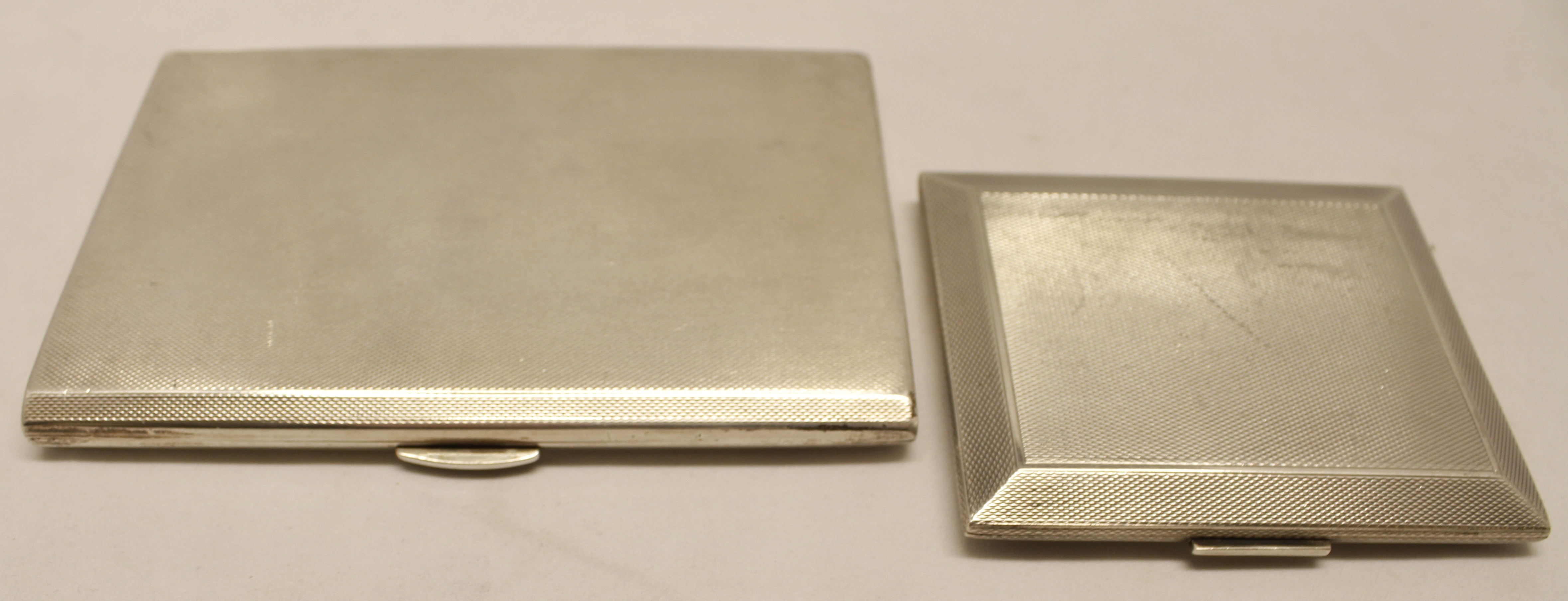 Mixed Lot: two various cigarette cases, each of hinged rectangular form with all-over engine-