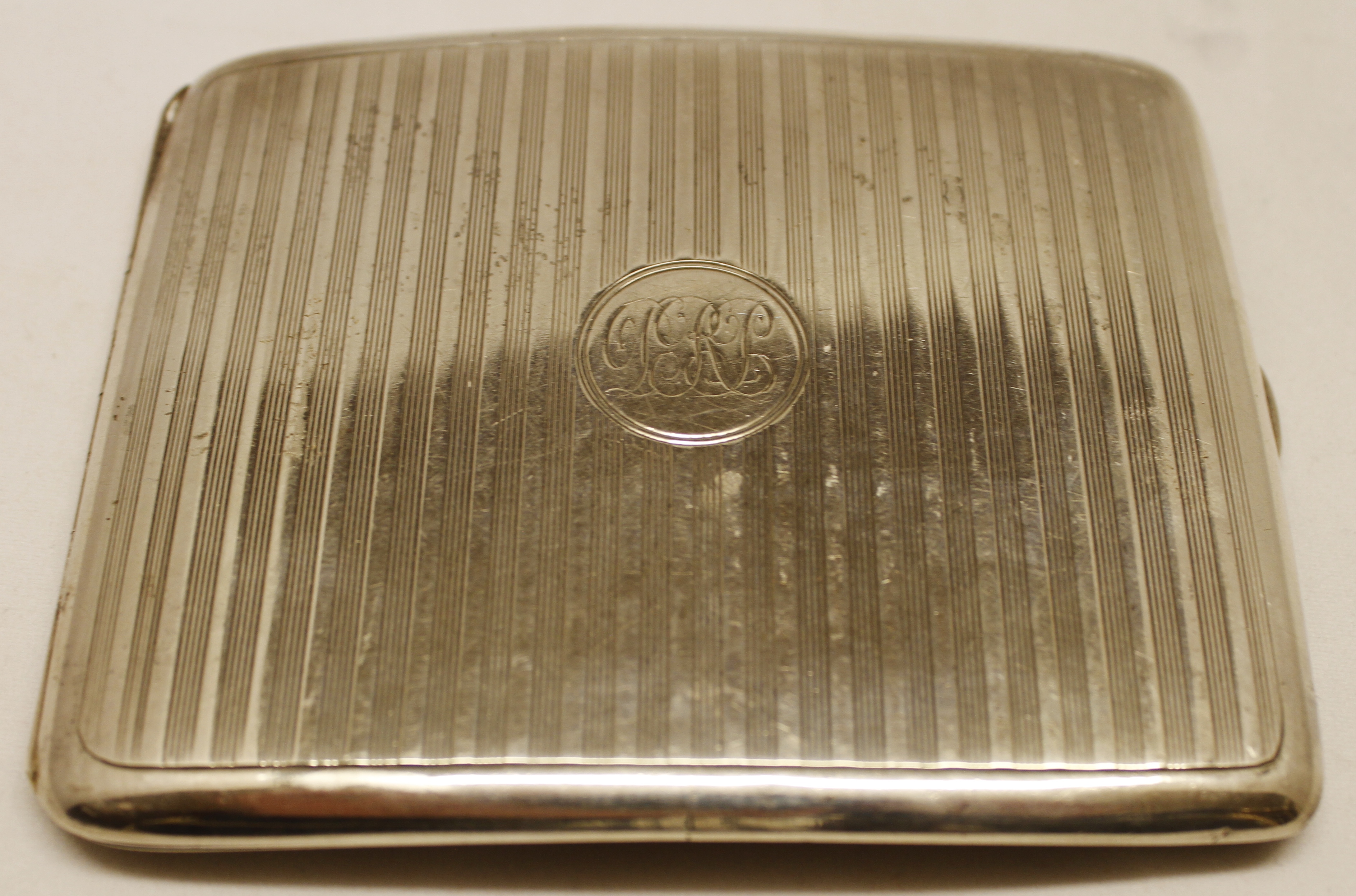 George V cigarette case of hinged rectangular form with engine turned decoration, Birmingham 1916,