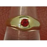 Mid-grade yellow metal ring, the centre set with a circular coloured stone (marks are rubbed),