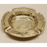 Elizabeth II circular ashtray, with cast and applied Celtic border and polished field, diameter 4