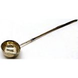 Early 19th century silver and whalebone toddy ladle, the oval bowl with pouring spout and coin