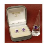 Precious metal amethyst and diamond ring, the circular cut amethyst with pierced shoulders set