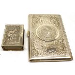 Mid-20th century Eastern white metal cigarette case of hinged and sprung form, the cover decorated