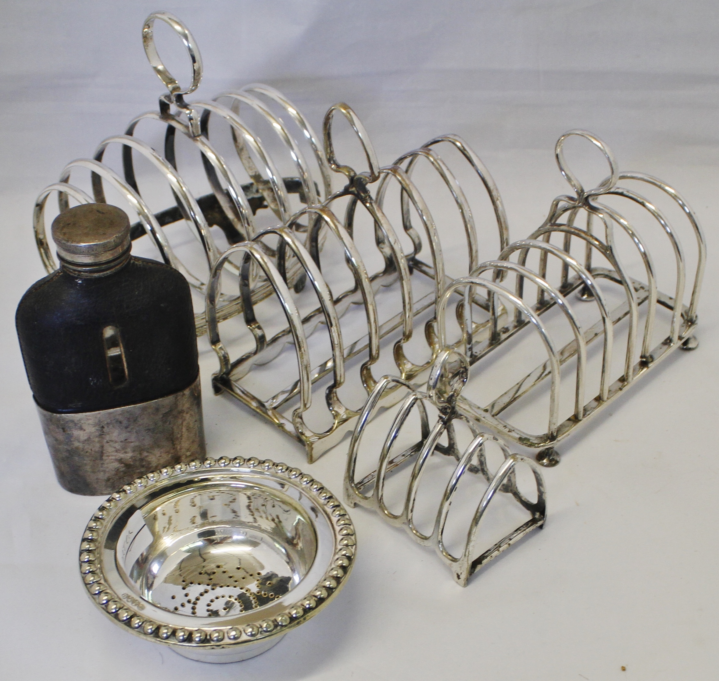 Mixed Lot: four various electroplated toast racks, together with a part wine funnel and clear