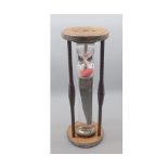 Clear glass egg-timer, in turned wooden frame, 17" high