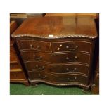 20th century reproduction serpentine bedroom chest with brushing slide over two short and three long