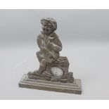 Unusual base metal pocket watch stand, formed as a seated figure, complete with an Enigma base metal