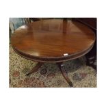 Georgian mahogany circular dining table, raised on quatre support with brass end caps and casters,
