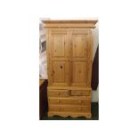 Modern pine wardrobe, the top with two doors over a four drawer base