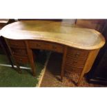 Edwardian mahogany kidney-shaped desk with leather inset top and seven drawers, 52" wide