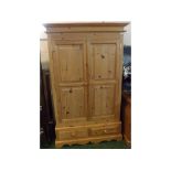 20th century pine wardrobe, with two large panelled doors over a two drawer base
