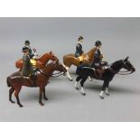 Collection of four painted lead model horses and riders, unsigned