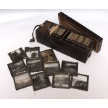 WOODEN CASE containing 70+ circa late 19th century photographic glass slides depicting mainly