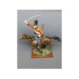 Shudehill model of a hussar on horseback, holding sword aloft, 18 tall, on wooden base