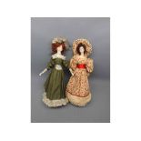 Two painted face dolls, one with a green dress with crochet neck and hem, together with a further