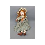 Heubach bisque headed doll with glass eyes and painted face, in a decorative floral dress, measuring