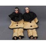 Near pair of mid-20th century porcelain and painted face dolls, modelled as clowns, in silk