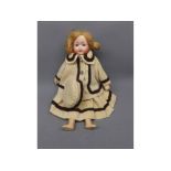 Schoenau & Hoffmeister porcelain faced doll in beige and brown lined matching coat and dress with