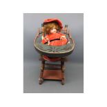 Small bisque doll marked Germany 985 together with a further doll s painted high chair, chair