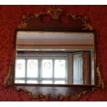 George II style mahogany and giltwood mounted wall mirror of shaped rectangular form, the
