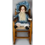 Late 20th Century doll with porcelain face, hands and feet, blue eyes, long brown hair, cloth