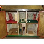 Large distinctive triple bay-fronted doll's house, English circa 1910, Back opening, two doors on