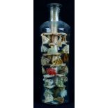 19th Century cylindrical glass bottle now containing a silk work 'tree' with tassels, 17cm tall,