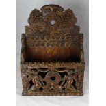 Late 19th Century carved oak candle or letter rack in 17th Century style, carved to the front with a