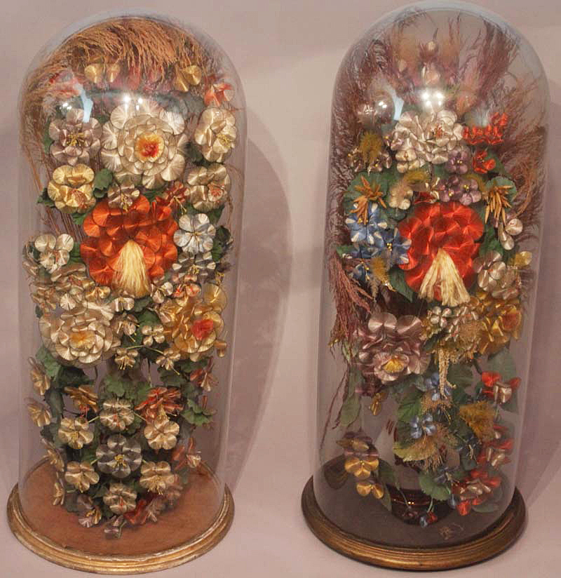 Large pair of Victorian silk work flower decorations under glass domes with circular gilded wood