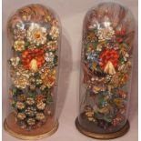 Large pair of Victorian silk work flower decorations under glass domes with circular gilded wood