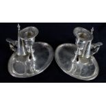 Pair of George IV oval silver chamber sticks, the bases with reeded borders, the stands, sconces and