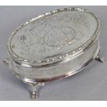 George V oval silver encased ring box, the lid engraved with ribbon tie and bell flower garland