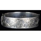 Late 20th Century hallmarked solid silver oval hinged bangle, the front engraved with scroll and