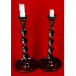 Pair of early 20th Century oak barley twist candlesticks with circular dished bases and metal