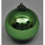 Green glass 'witches ball' with brass hanging ring approximately 8cm diameter, traditionally used to