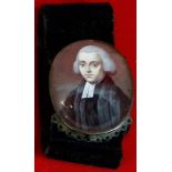 19th Century mourning amulet of black felt with oval oil painted miniature of a clergyman (unsigned,