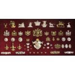 Wall cabinet containing an assembly of some 56 Livery and Military badges and metalled horse