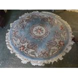 Blue and cream ground circular oriental thick pile carpet, with central circular rose lozenge with