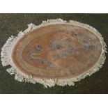 Pink ground Chinese thick pile oval wool carpet, with Grecian style key border with central dragon