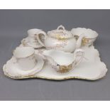 Limoges breakfast tea set: teapot, sugar basin and cream jug, two cups and saucers, and accompanying