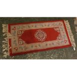 Chinese thick pile red and cream ground wool wash carpet, with floral borders and Grecian Key