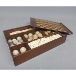 Antique mahogany and inlaid games box, containing various gaming pieces, marbles etc